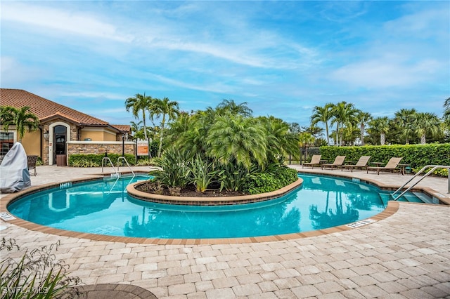 8021 Calle Canovas Ct, Naples, FL 34114 - community pool featuring a patio and fence
