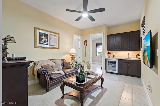 4802 Frattina St, Ave Maria, FL 34142 - living area with beverage cooler, bar with sink, light tile patterned flooring, ceiling fan, and baseboards
