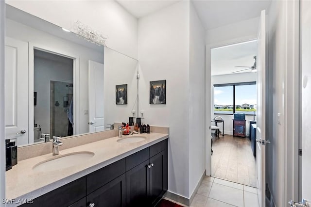 4802 Frattina St, Ave Maria, FL 34142 - full bath with double vanity, a stall shower, tile patterned floors, a ceiling fan, and baseboards