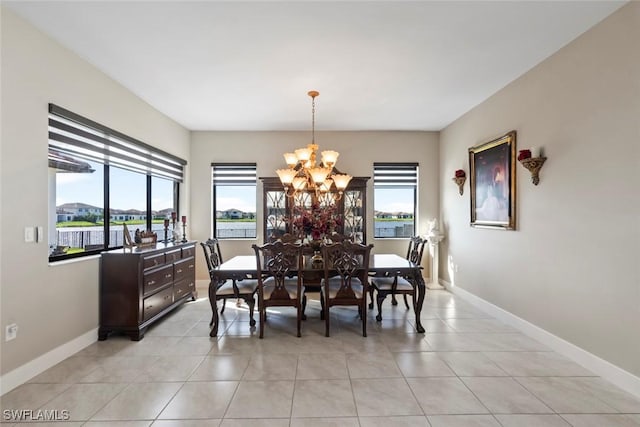 4802 Frattina St, Ave Maria, FL 34142 - dining room with a chandelier, healthy amount of natural light, light tile patterned flooring, and baseboards