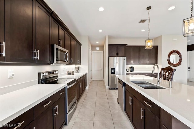 4802 Frattina St, Ave Maria, FL 34142 - kitchen featuring appliances with stainless steel finishes, a sink, light countertops, light tile patterned floors, and recessed lighting