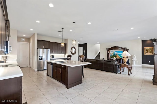4802 Frattina St, Ave Maria, FL 34142 - kitchen featuring stainless steel appliances, open floor plan, light countertops, dark brown cabinetry, and recessed lighting