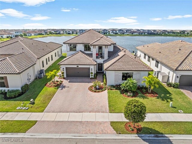 4802 Frattina St, Ave Maria, FL 34142 - view of front of house featuring a tiled roof, stucco siding, decorative driveway, a water view, and a residential view