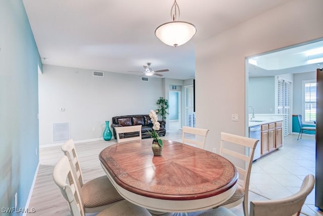 dining space featuring visible vents, a ceiling fan, and baseboards