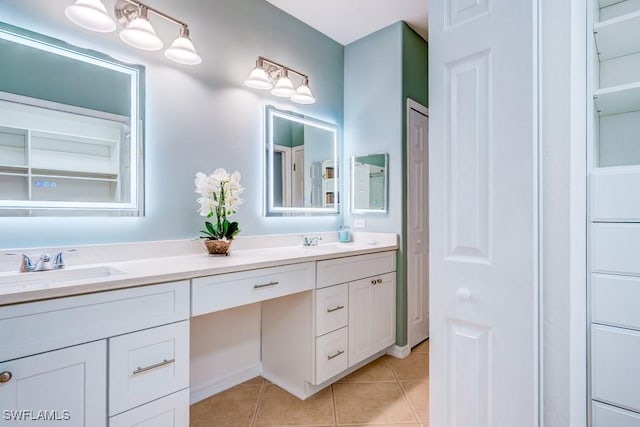 full bathroom with a sink, double vanity, and tile patterned floors