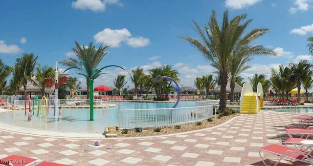community pool with fence and a patio