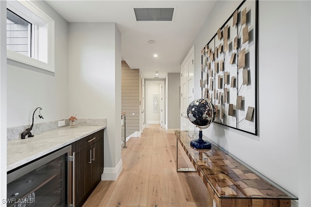 1230 Gulf Shore Blvd S, Naples, FL 34102 - corridor with beverage cooler, light wood-type flooring, baseboards, and recessed lighting
