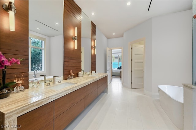 1230 Gulf Shore Blvd S, Naples, FL 34102 - ensuite bathroom with a freestanding tub, double vanity, recessed lighting, baseboards, and tile patterned flooring
