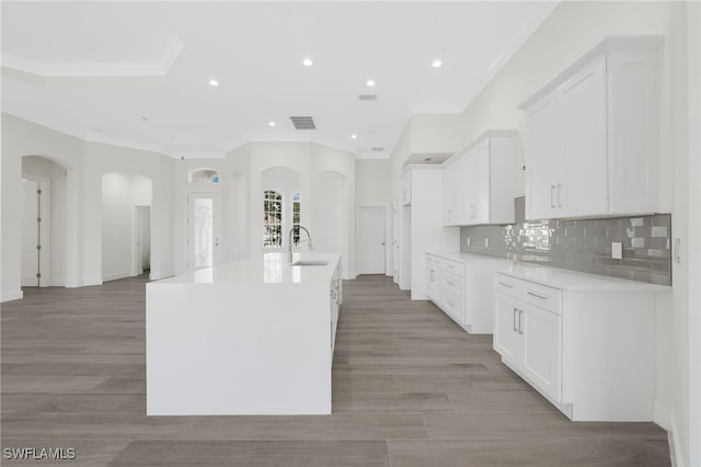 16404 Coco Hammock Way, Fort Myers, FL 33908 - kitchen featuring ornamental molding, white cabinetry, arched walkways, light countertops, and recessed lighting