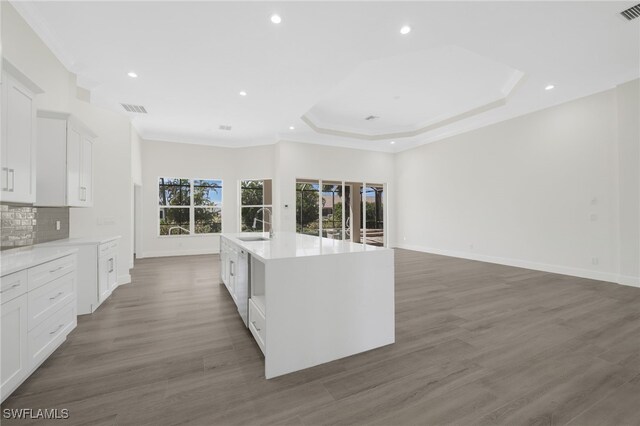 16404 Coco Hammock Way, Fort Myers, FL 33908 - kitchen with light countertops, white cabinets, a center island with sink, tasteful backsplash, and recessed lighting