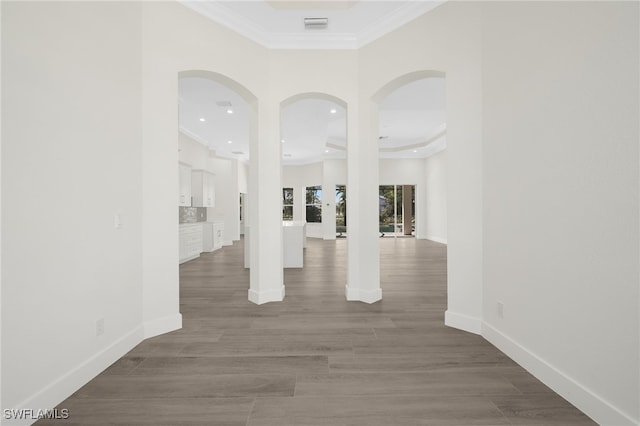 16404 Coco Hammock Way, Fort Myers, FL 33908 - empty room featuring ornamental molding, recessed lighting, wood finished floors, arched walkways, and a raised ceiling
