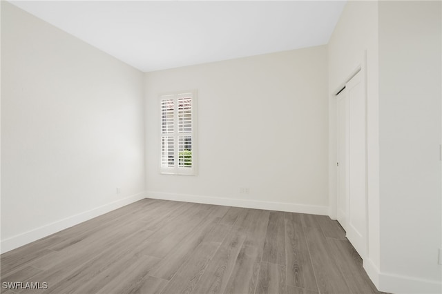 16404 Coco Hammock Way, Fort Myers, FL 33908 - unfurnished bedroom with wood finished floors and a closet