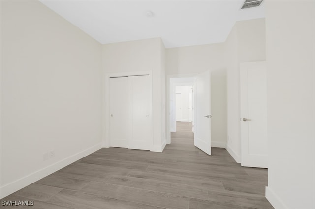 16404 Coco Hammock Way, Fort Myers, FL 33908 - unfurnished bedroom featuring wood finished floors and a closet