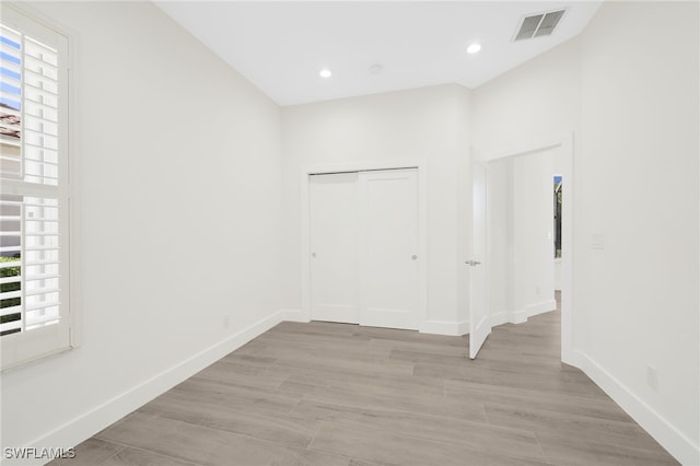 16404 Coco Hammock Way, Fort Myers, FL 33908 - unfurnished bedroom featuring light wood-style flooring, a closet, and recessed lighting