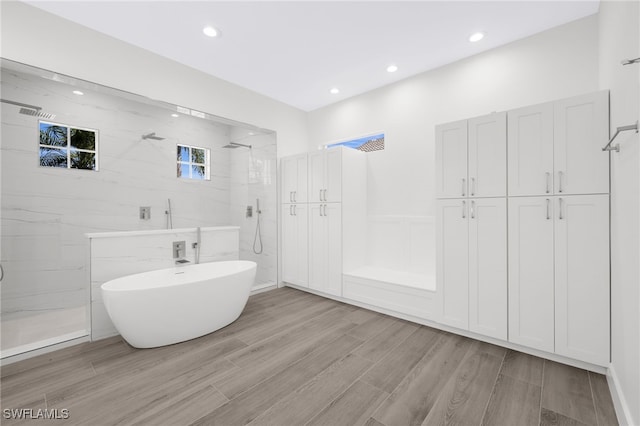 16404 Coco Hammock Way, Fort Myers, FL 33908 - full bath with a freestanding tub, wood finished floors, a marble finish shower, and recessed lighting