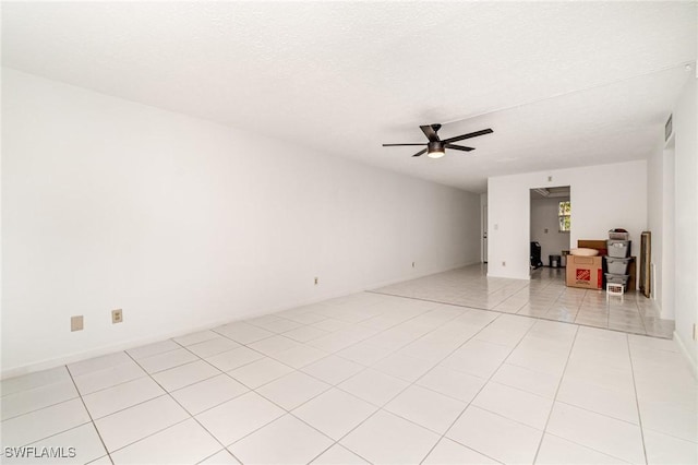 1006 SE 46th St Unit 1C, Cape Coral, FL 33904 - spare room with light tile patterned flooring, visible vents, a textured ceiling, and ceiling fan