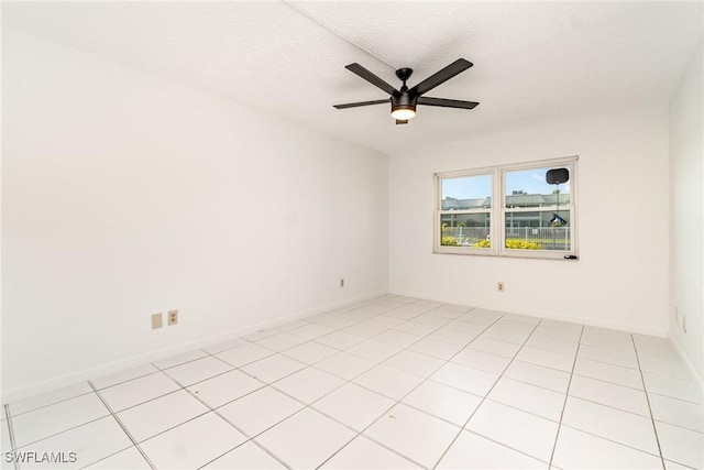 1006 SE 46th St Unit 1C, Cape Coral, FL 33904 - unfurnished room featuring baseboards, light tile patterned floors, a textured ceiling, and ceiling fan