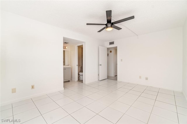 1006 SE 46th St Unit 1C, Cape Coral, FL 33904 - empty room with light tile patterned floors, visible vents, a textured ceiling, and ceiling fan
