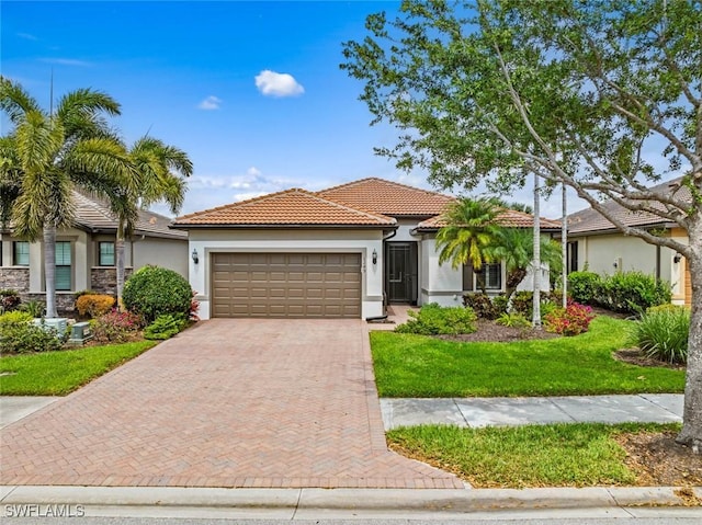 view of front of property with a tile roof, decorative driveway, an attached garage, and stucco siding