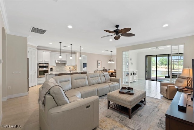 living area featuring visible vents, recessed lighting, crown molding, light tile patterned floors, and ceiling fan