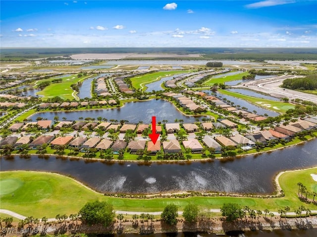 aerial view with a residential view, golf course view, and a water view
