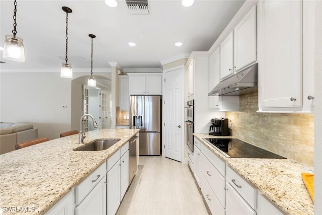kitchen featuring visible vents, a sink, ornamental molding, stainless steel appliances, and under cabinet range hood