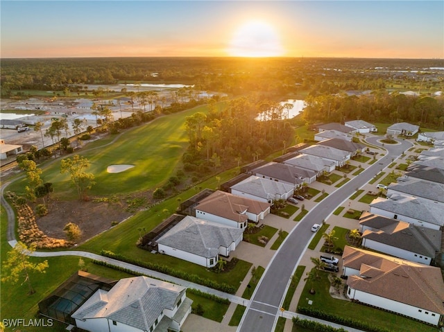 aerial view with a residential view, golf course view, and a water view