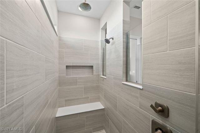 full bathroom with visible vents and a tile shower