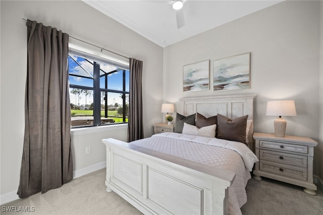 bedroom with ceiling fan, baseboards, and light carpet