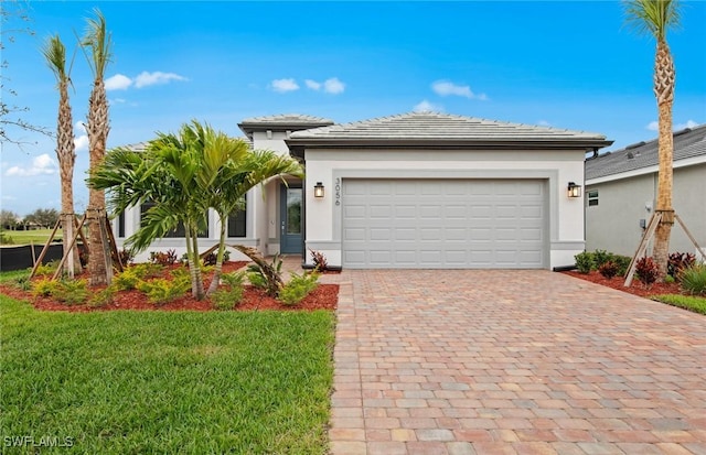 3056 Weston Manor Dr, Alva, FL 33920 - view of front facade with decorative driveway, a front lawn, an attached garage, and stucco siding