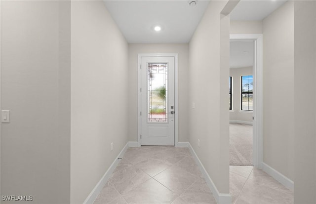 3056 Weston Manor Dr, Alva, FL 33920 - doorway with light tile patterned floors, a healthy amount of sunlight, and baseboards