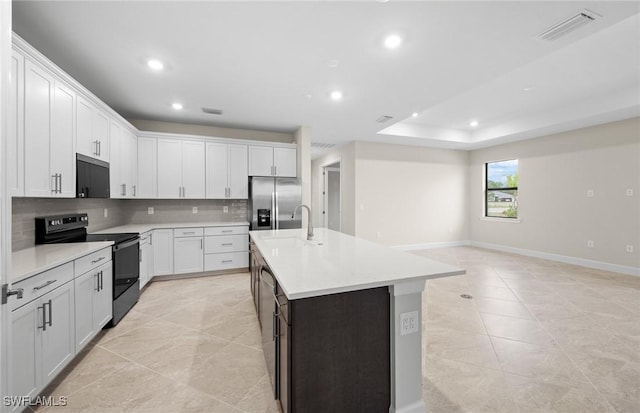 3056 Weston Manor Dr, Alva, FL 33920 - kitchen with visible vents, a sink, decorative backsplash, stainless steel refrigerator with ice dispenser, and range with electric stovetop