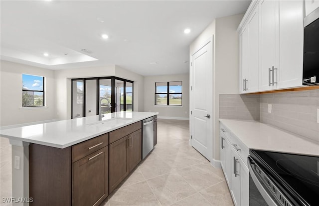 3056 Weston Manor Dr, Alva, FL 33920 - kitchen with a sink, stainless steel appliances, white cabinets, and light countertops