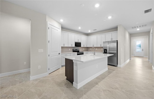 3056 Weston Manor Dr, Alva, FL 33920 - kitchen with a sink, decorative backsplash, visible vents, and stainless steel appliances