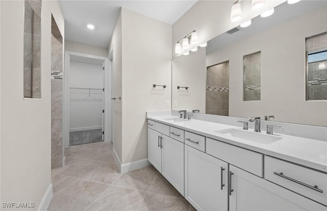 3056 Weston Manor Dr, Alva, FL 33920 - bathroom featuring double vanity, a spacious closet, a walk in shower, and a sink