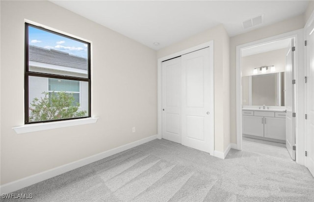3056 Weston Manor Dr, Alva, FL 33920 - unfurnished bedroom with light colored carpet, visible vents, a closet, and baseboards