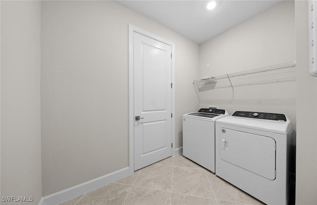 3056 Weston Manor Dr, Alva, FL 33920 - washroom featuring light tile patterned floors, baseboards, laundry area, and washing machine and clothes dryer