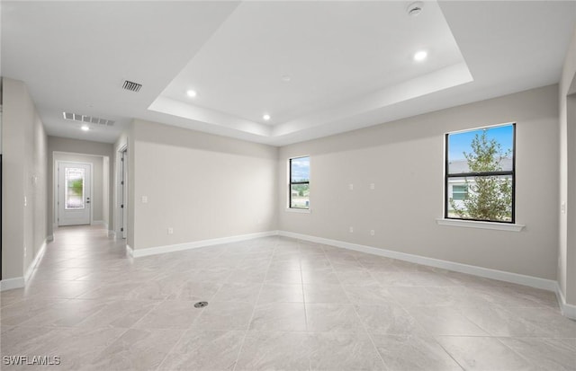 3056 Weston Manor Dr, Alva, FL 33920 - unfurnished room with a tray ceiling, baseboards, and visible vents