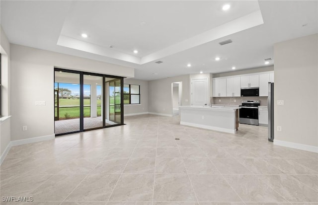 3056 Weston Manor Dr, Alva, FL 33920 - unfurnished living room with recessed lighting, baseboards, and a raised ceiling