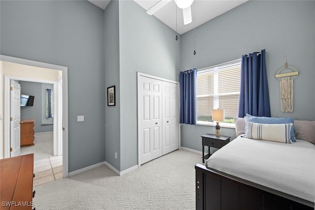 19765 Vintage Trace Cir, Estero, FL 33967 - bedroom with baseboards, high vaulted ceiling, a closet, and light colored carpet