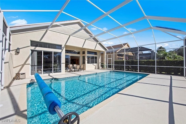 19765 Vintage Trace Cir, Estero, FL 33967 - outdoor pool with a patio area, glass enclosure, and a ceiling fan