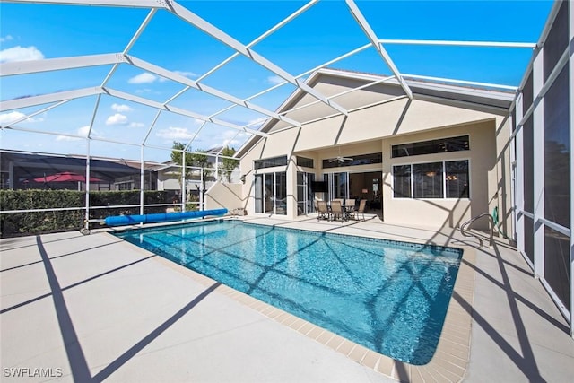 19765 Vintage Trace Cir, Estero, FL 33967 - view of pool featuring glass enclosure, a patio area, ceiling fan, and a covered pool