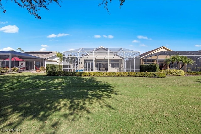 19765 Vintage Trace Cir, Estero, FL 33967 - back of house featuring a lawn