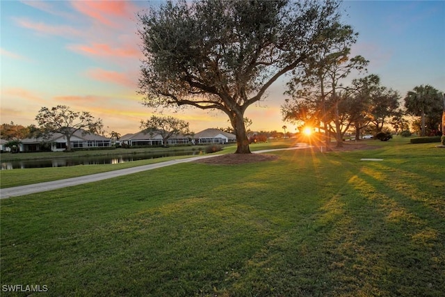19765 Vintage Trace Cir, Estero, FL 33967 - surrounding community featuring a lawn, driveway, a residential view, and a water view