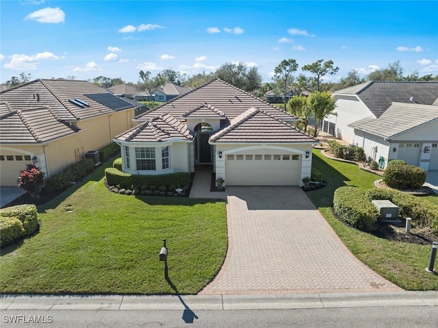 19765 Vintage Trace Cir, Estero, FL 33967 - ranch-style home featuring an attached garage, a tile roof, a front lawn, and driveway