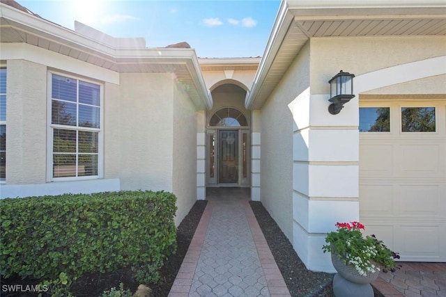 19765 Vintage Trace Cir, Estero, FL 33967 - view of exterior entry featuring stucco siding and a garage