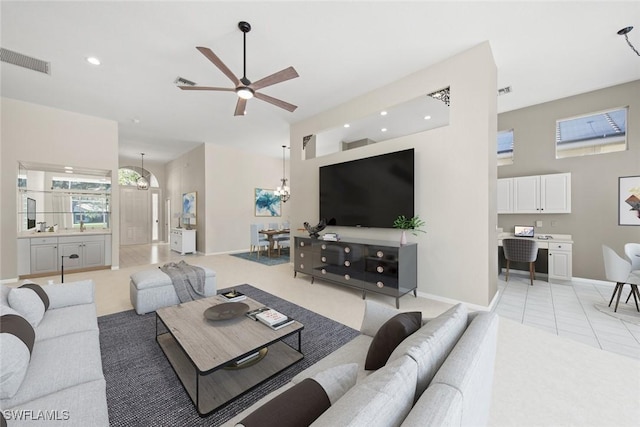 19765 Vintage Trace Cir, Estero, FL 33967 - living room with baseboards, light carpet, visible vents, and ceiling fan with notable chandelier