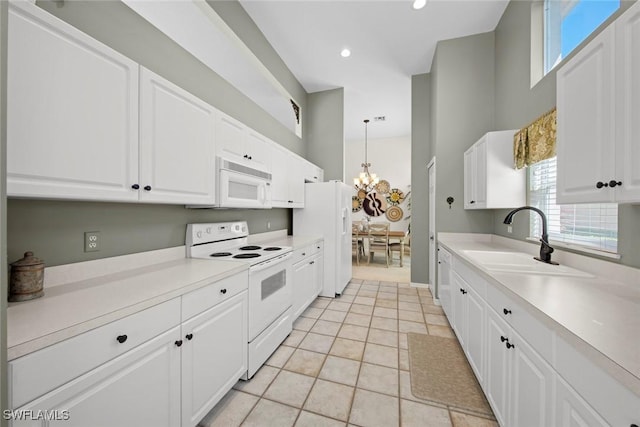 19765 Vintage Trace Cir, Estero, FL 33967 - kitchen featuring a chandelier, a sink, white appliances, and plenty of natural light