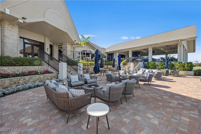 19765 Vintage Trace Cir, Estero, FL 33967 - view of patio featuring ceiling fan, stairs, and an outdoor living space with a fire pit