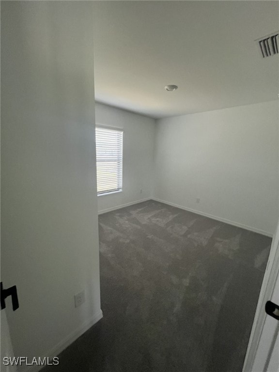 844 Gedeon Rd, Lehigh Acres, FL 33974 - unfurnished room with dark carpet and baseboards
